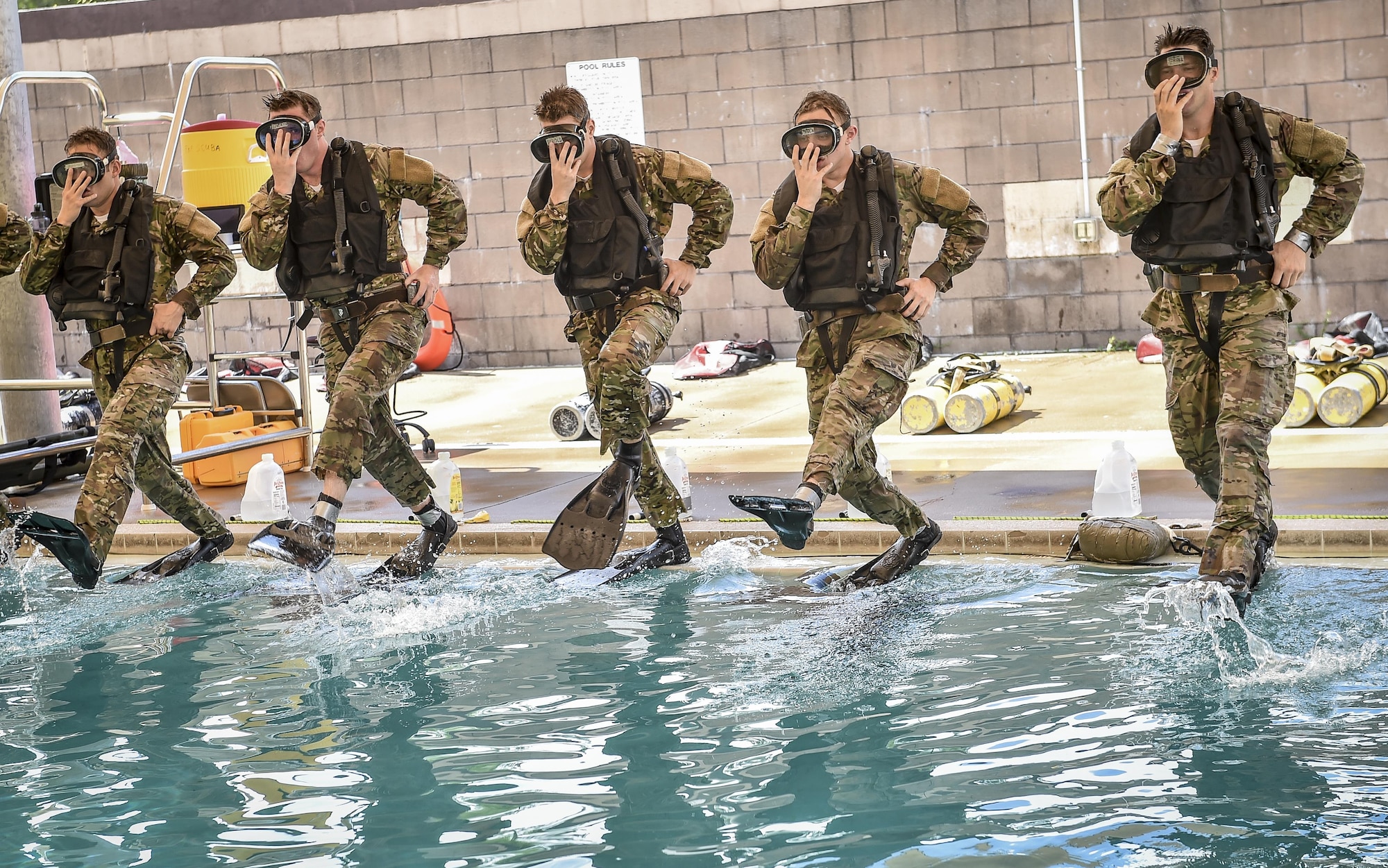 Special Tactics Training Squadron students jump into the pool in scuba gear during a pre-scuba class at Hurlburt Field, Fla., June 29, 2016. The training familiarizes trainees with the basics of water operations. The trainees perform tasks such as tying knots underwater, learning how to stay afloat without their arms and hands, and how to use snorkeling gear. Special Tactics students later apply this knowledge to combat dive training. This training also reproduces physiological effects similar those experienced on the battlefield, and thus builds the necessary mental resiliency for ground special operations force. (U.S. Air Force photo by Senior Airman Ryan Conroy) 