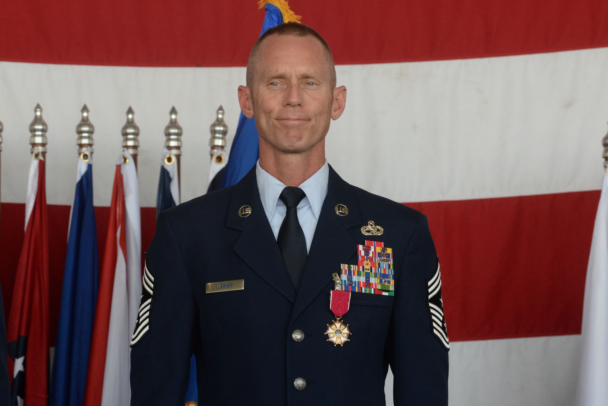 Chief Master Sgt. Geoff Weimer smiles as he is officially relieved from active duty at his retirement ceremony at Minot Air Force Base, N.D., June 24, 2016. Weimer served as the command chief of the 5th Bomb Wing since July 2014. (U.S. Air Force photo/Airman 1st Class Jessica Weissman)