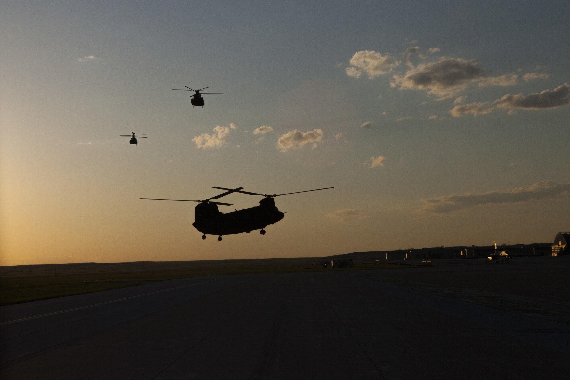 Three Republic of Singapore Air Force CH-47 D Chinook helicopters return to Ellsworth Air Force Base, S.D., after performing sling load operations in support of the Golden Coyote training exercise at the South Dakota National Guard West Camp Rapid training facility, Rapid City, S.D., June 14, 2016. The Golden Coyote exercise is a three-phase, scenario-driven exercise conducted in the Black Hills of South Dakota and Wyoming, which enables commanders to focus on mission essential task requirements, warrior tasks and battle drills. (U.S. Army photo by Spc. Kristen Root/Released)