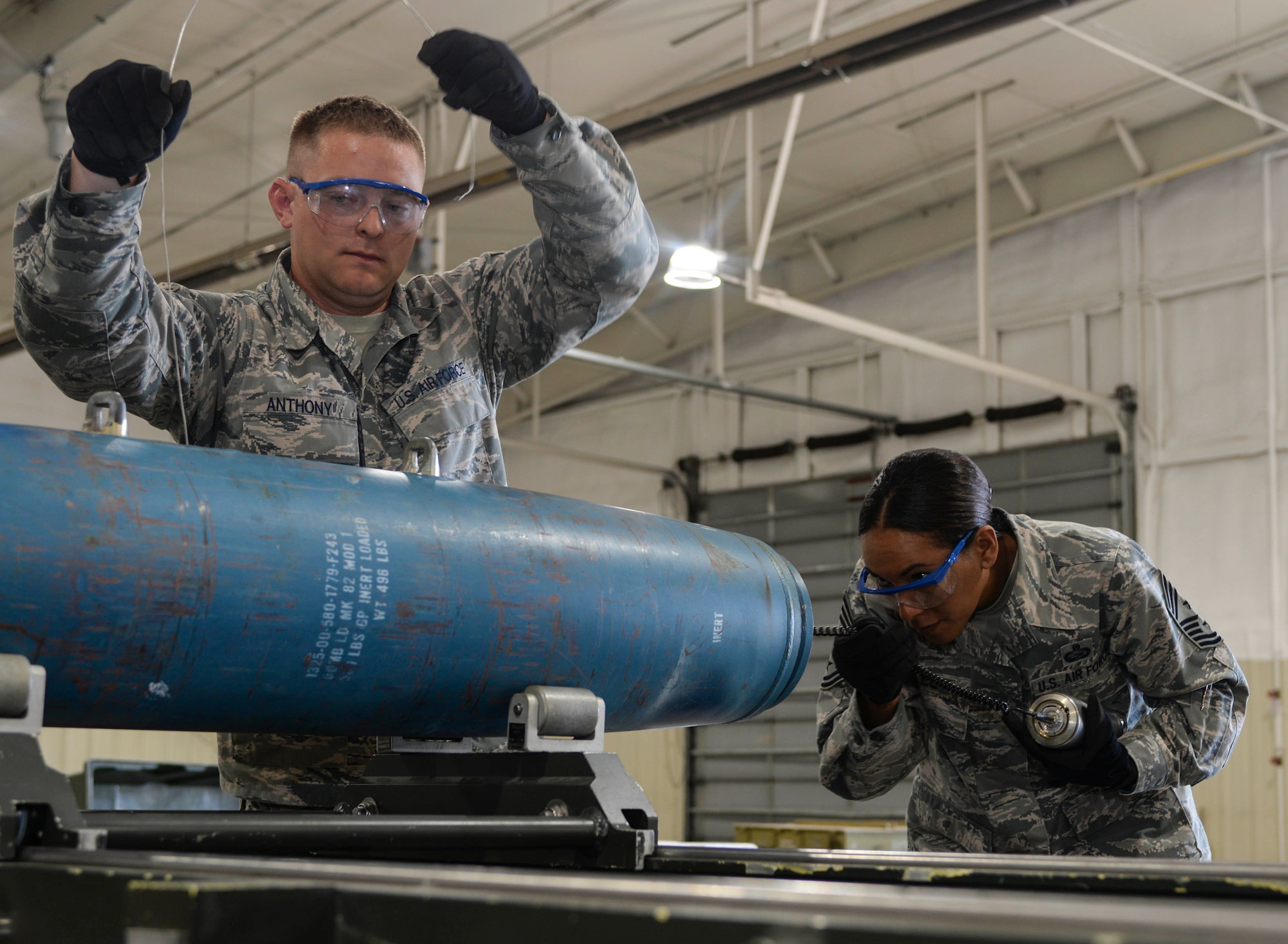 Senior Airman Justin Anthony, 28th Munitions Squadron conventional maintenance crew chief, left, assists Chief Master Sgt. Sonia Lee, 28th Bomb Wing command chief, in loading an FM-152 fuse into an inert GBU-38 v1 during an immersion tour at Ellsworth Air Force Base, S.D., June 27, 2016. Ellsworth’s conventional maintenance crews take an average of 25 minutes to build the 500-pound munition. (U.S. Air Force photo by Airman 1st Class Sadie Colbert/Released)