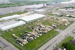 Military vehicles and equipment wait to be loaded from a new seaport facility created by DLA expeditionary logistics teams at Port Arthur, Texas, for Turbo Distribution 16-4 in April 2016.