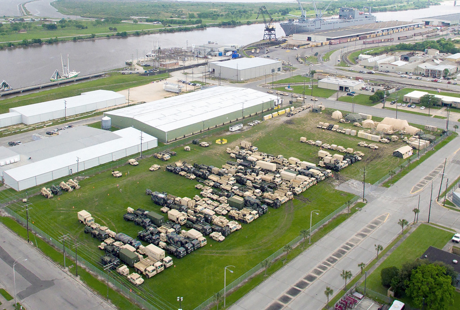 Military vehicles and equipment wait to be loaded from a new seaport facility created by DLA expeditionary logistics teams at Port Arthur, Texas, for Turbo Distribution 16-4 in April 2016.