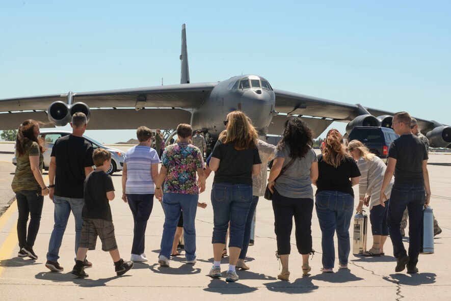 Family and friends of Chief Master Sgt. Geoff Weimer wait for Weimer to debark a B-52 Stratofortress to celebrate his final flight at Minot Air Force Base, N.D., June 23, 2016. It is an Air Force tradition to have family, friends and Airmen from the wing toast the departing aircrew member and hose him down with water as they debark the aircraft. (U.S. Air Force photo/Airman 1st Class Jessica Weissman)