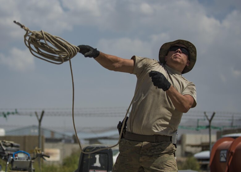 Senior Airman Eric Woolston, a 455th Expeditionary Civil Engineer Squadron structural journeyman, throws a rope over a tent skeleton June 25, 2016, at Bagram Airfield, Afghanistan. All flights within the 455th ECES, including structures, dirt boys and electrical, came together to build a tent that will be the new location of the power production and heating, ventilation and air conditioning shops. (U.S. Air Force photo/Senior Airman Justyn M. Freeman)