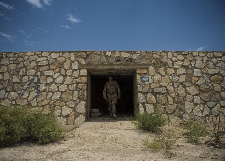 Staff Sgt. Gary Allsbrook, a 455th Expeditionary Security Forces Squadron quick reaction force member, walks out of an old bunker June 27, 2016, at Bagram Airfield, Afghanistan. The squadron’s QRF teams check buildings and other areas on the flightline in order to deter threats. (U.S. Air Force photo/Senior Airman Justyn M. Freeman)