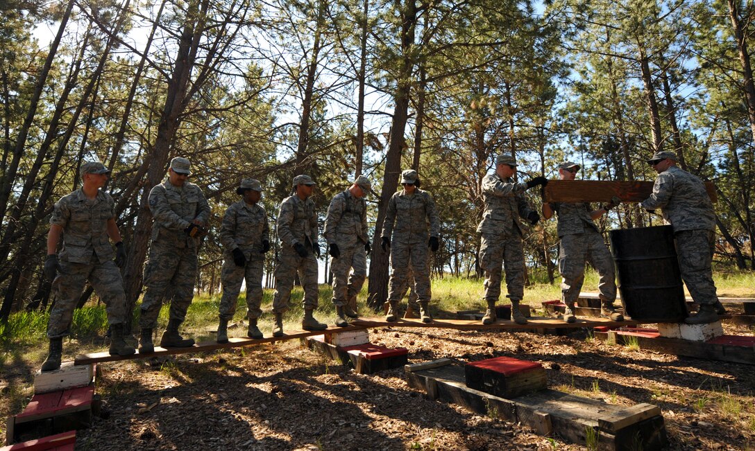 Airmen From the 28th Civil Engineer Squadron participate in a leadership reaction course at the South Dakota National Guard West Camp Rapid training facility, Rapid City, S.D., June 17, 2016. The purpose of the LRC was to develop teamwork building and communication skills. (U.S. Air Force photo by Airman 1st Class Denise M. Nevins/Released)