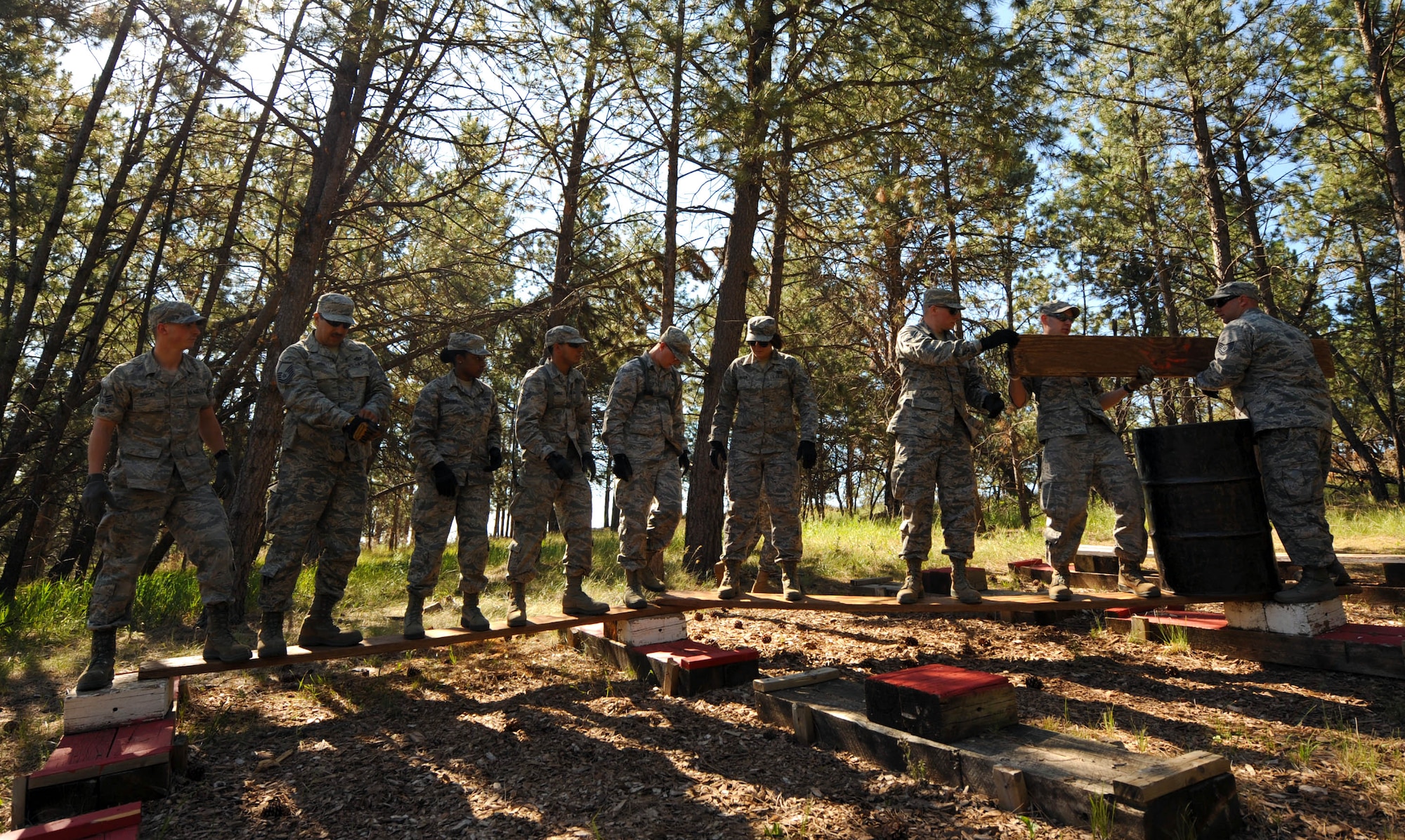 Airmen From the 28th Civil Engineer Squadron participate in a leadership reaction course at the South Dakota National Guard West Camp Rapid training facility, Rapid City, S.D., June 17, 2016. The purpose of the LRC was to develop teamwork building and communication skills. (U.S. Air Force photo by Airman 1st Class Denise M. Nevins/Released)