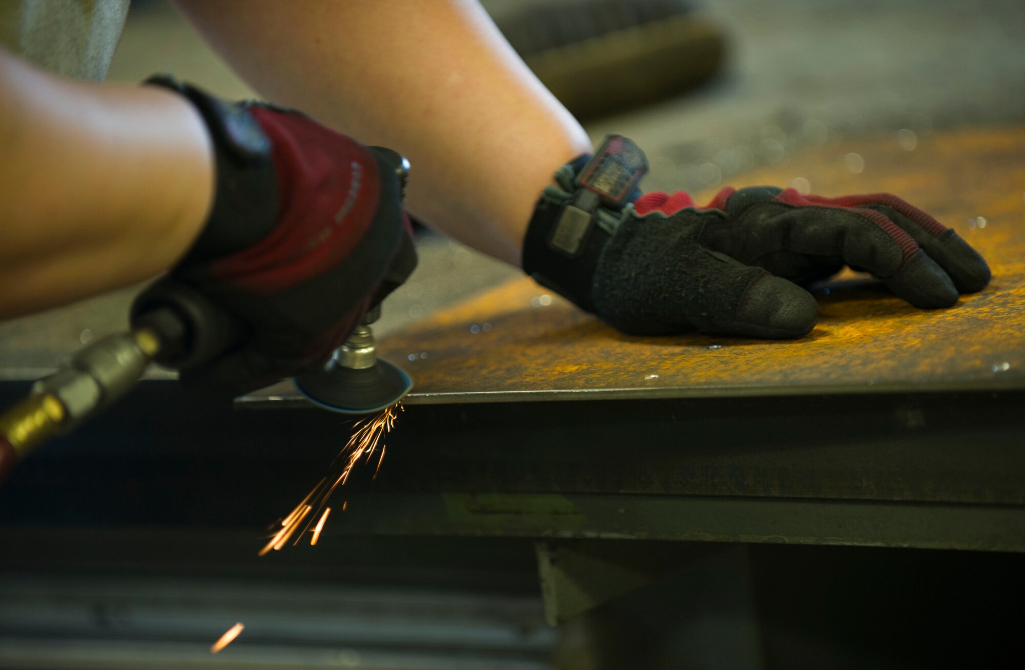 Airman 1st Class Megan Causey, 5th Maintenance Squadron metals technology journeyman, works on a sheet of metal at Minot Air Force Base, N.D., June 29, 2016. Metals techs are responsible for preparing parts for aircraft, equipment and weapons systems. (U.S. Air Force photo/Senior Airman Apryl Hall)