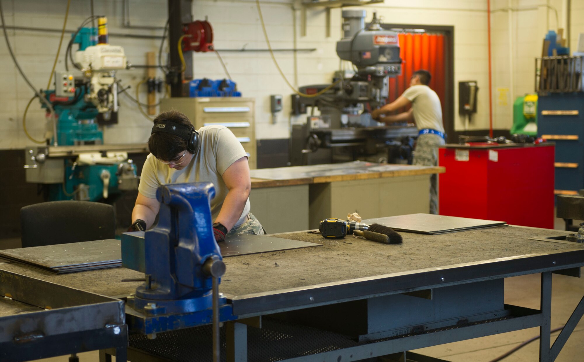 Metals technicians from the 5th Maintenance Squadron work in their shop at Minot Air Force Base, N.D., June 29, 2016. The unit creates and maintains essential parts for aircraft, equipment and weapons systems. (U.S. Air Force photo/Senior Airman Apryl Hall)