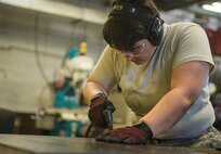 Airman 1st Class Megan Causey, 5th Maintenance Squadron metals technology journeyman, works on a sheet of metal at Minot Air Force Base, N.D., June 29, 2016. Causey was preparing the sheet of metal for a B-52H Stratofortress. (U.S. Air Force photo/Senior Airman Apryl Hall)