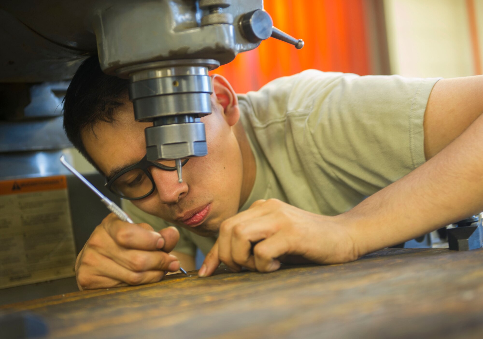 Airman 1st Class David Saravia, 5th Maintenance Squadron metals technology journeyman, drills holes on a piece of sheet metal at Minot Air Force Base, N.D., June 29, 2016. Metals techs are responsible for preparing parts for aircraft, equipment and weapons systems. (U.S. Air Force photo/Senior Airman Apryl Hall)