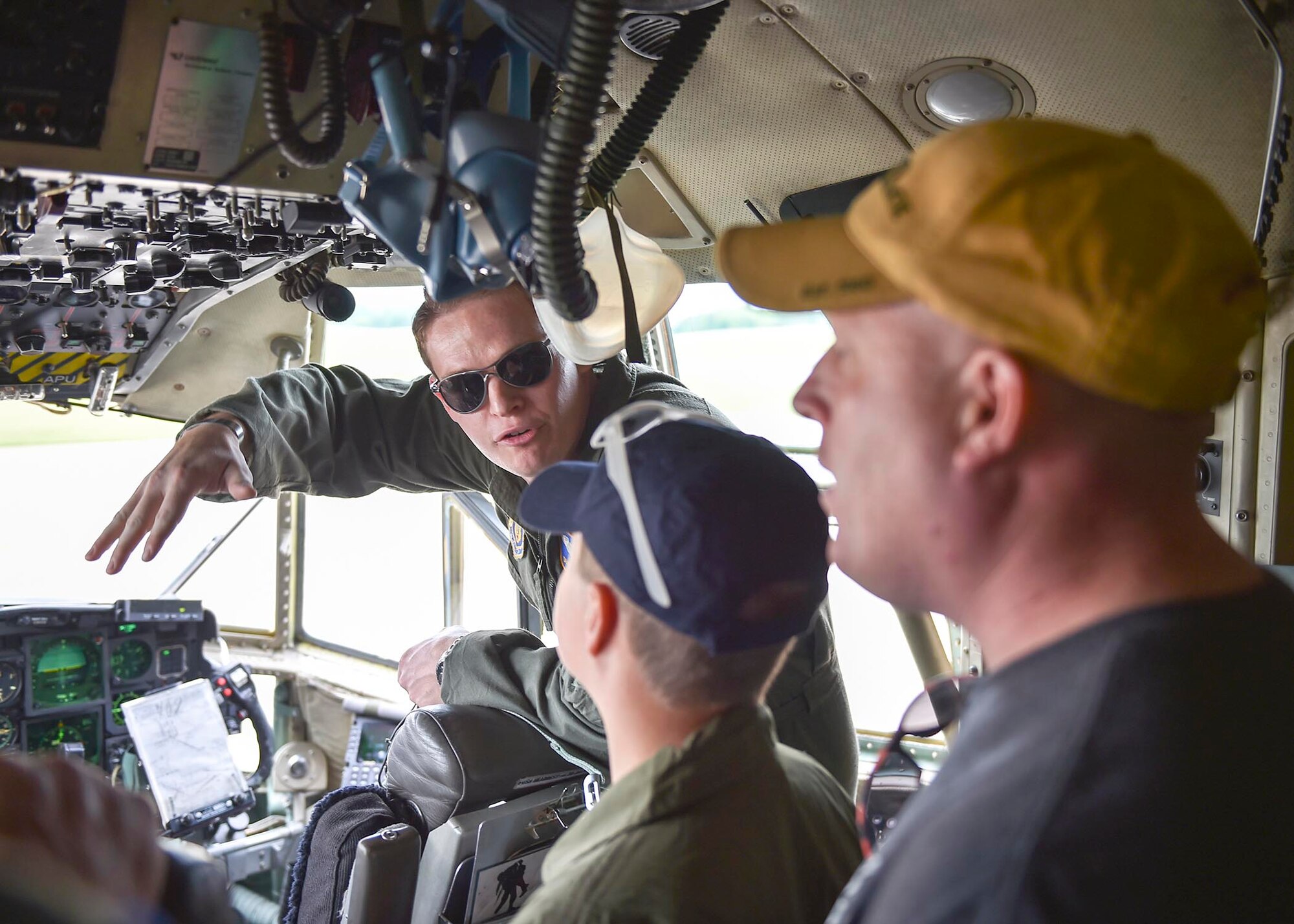 Lt. Devin Keigley, a pilot with the 757th Airlift Squadron here, explains the controls of a C-130H Hercules aircraft to honorary 2nd Lt. Corbin Burggraf, the 910th Airlift Wing’s 63rd Pilot for a Day, and Corbin’s father George here, June 29. The Pilot for a Day program welcomes children with life threatening or chronic illnesses to Youngstown Air Reserve Station for a day of fun military experiences. Keigley was Burggraf’s pilot escort for his day at YARS. (U.S. Air Force photo/Eric White)
