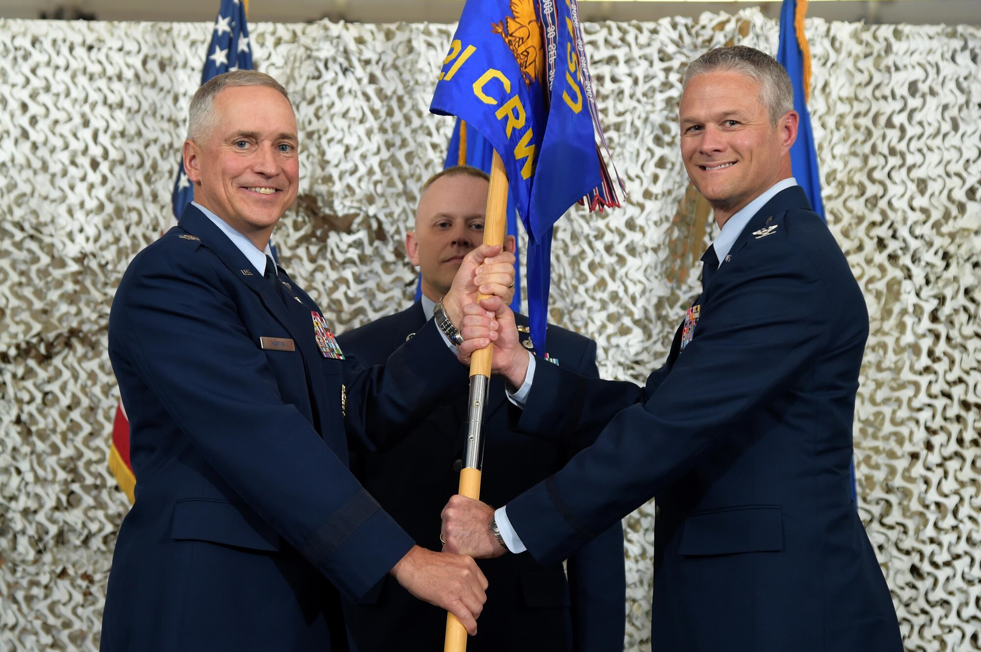 Maj. Gen. Frederick Martin, U.S. Expeditionary Center commander presents the unit flag to Col. Charles R. Henderson as he assumes command of the 621st Contingency Response Wing during the 621st CRW Change of Command Ceremony at Joint Base McGuire-Dix-Lakehurst, New Jersey, June 29, 2016. Henderson served as the Vice Commander of the 521st Air Mobility Operations Wing at Ramstein Air Base, Germany. (U.S. Air Force photo by Tech. Sgt. Gustavo Gonzalez/Released)