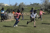 Children from the youth center at Minot Air Force Base, N.D., run toward their opponent during Paintball 101 June 17, 2016. This course was offered as a week-long summer camp for all members of the youth center. (U.S. Air Force photo/Airman 1st Class Jessica Weissman) 