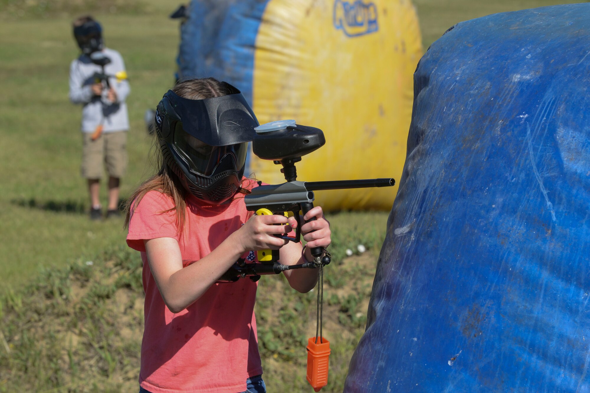 Natalie Drain, a member of the youth center at Minot Air Force Base, N.D., shoots a paintball gun during Paintball 101 June 17, 2016. Children learned the basic skills from skilled professionals and participated in a week-long camp offered to members of the youth center. (U.S. Air Force photo/Airman 1st Class Jessica Weissman)
