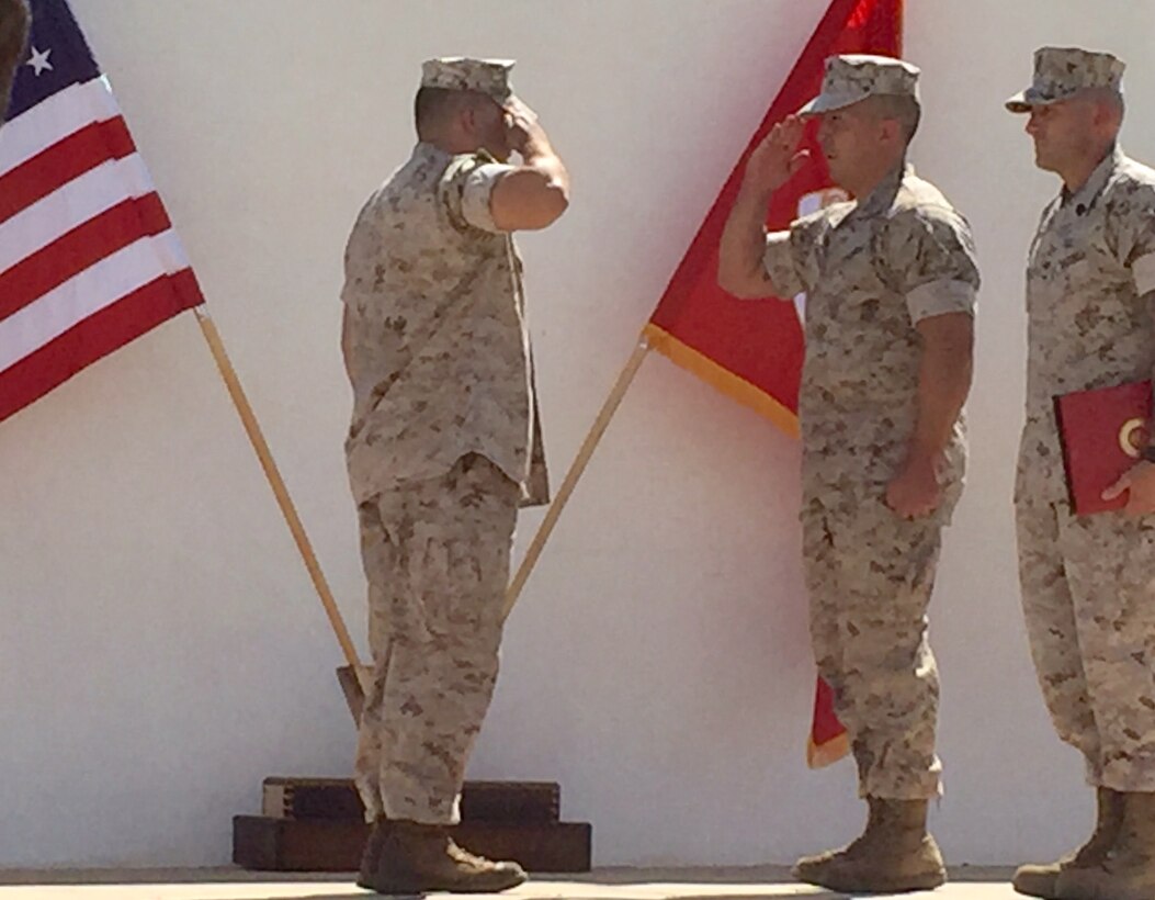 The Electronics Fundamental Training Section Officer-in-Charge, Captain Kyle Shoemaker, and the Alpha Company First Sergeant, Robert Ashby, retire Basic Electronics Course instructor Gunnery Sergeant Diego Olivarez during a ceremony on 10 June, 2016 at Heritage Park.  Gunnery Sergeant Olivarez faithfully served the Marine Corps for 20 years.