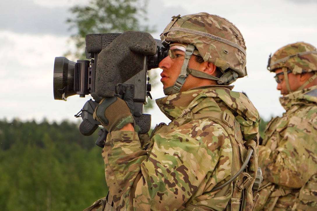 Army Pvt. Joseph Morales, foreground, uses a command launch unit to look for his target during Saber Strike 16 in Tapa, Estonia, June 20, 2016. Morales is a cavalry scout assigned to the 2nd Cavalry Regiment. Army photo by Staff Sgt. Jennifer Bunn