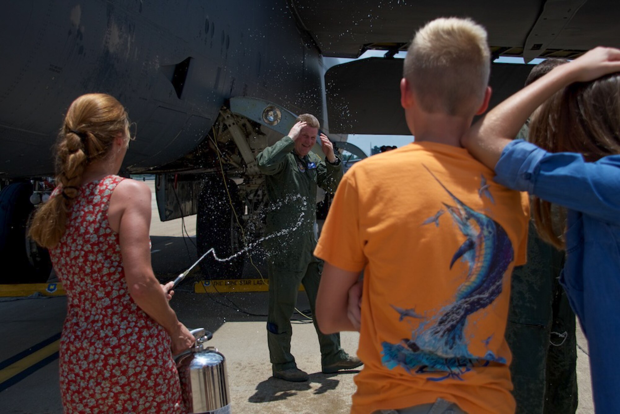 Friends and family hose down U.S. Air Force Lt. Col. Christopher Talbot as he exits a B-52 Stratofortress for the last time on Barksdale Air Force Base, La. on June 19, 2016. Talbot is assigned to the 93rd Bomb Squadron at Barksdale and is retiring from the Air Force Reserve. (U.S. Air Force photo by Senior Airman Callie Ware/Released)
