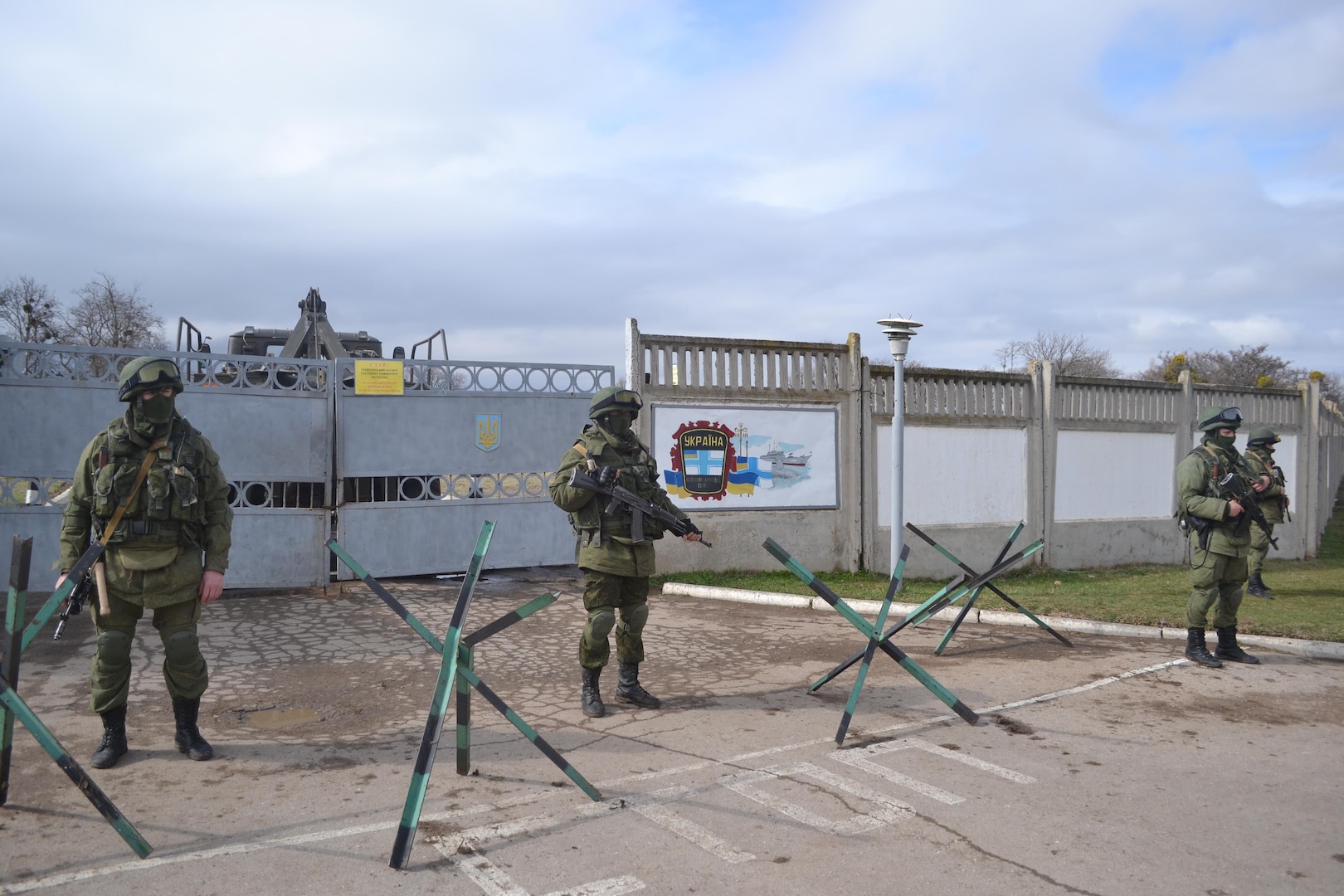 Known as the “little green men,” Russian soldiers stand watch over Perevalne military base in Crimea. (March 2014)
