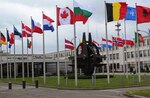 The flags of the 28 NATO member countries flap in the wind in front of headquarters in Brussels. 