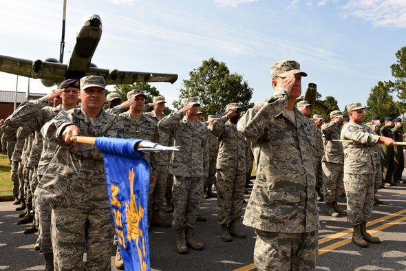 Airmen in formation salute during the 4th Fighter Wing change of command ceremony, June 30, 2016, at Seymour Johnson Air Force Base, North Carolina. Col. Christopher Sage assumed command from Col. Mark Slocum during the ceremony. (U.S. Air Force photo/ Airman 1st Class Ashley Williamson)