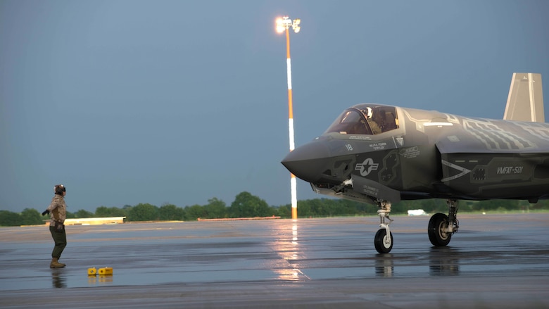 A Marine guides an F-35B Lightning II at Royal Air Force Base Fairford in the United Kingdom after the first F-35 trans-Atlantic flight, June 29, 2016. Three F-35B’s flew from Marine Corps Air Station Beaufort, South Carolina and landed at RAF Fairford in Gloucester, England. They were assisted by two KC-10’s and refueled 15 times over the Atlantic Ocean. 