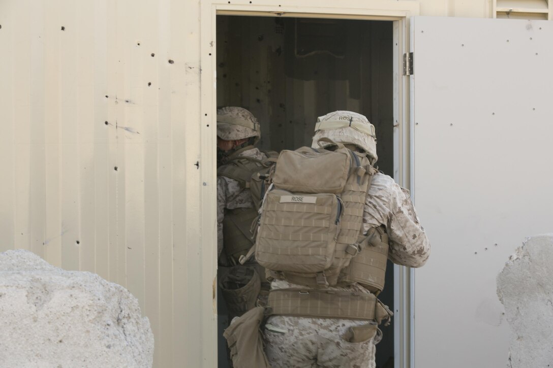 Marines of Company I, 3rd Battalion, 4th Marines, 7th Marine Regiment, clear a building during a Marine Air Ground Task Force Integration Exercise at the Chocolate Mountain Training Area, Yuma, Ariz., June 22, 2016. This integration training tested the ground combat element and air combat element ability to work together to perform the insert of troops in defense of a territory. (Official Marine Corps photo by Cpl. Thomas Mudd/Released)