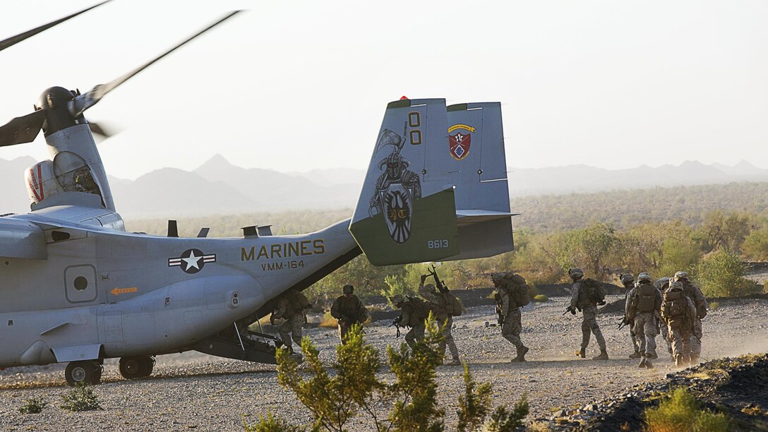 Marines of Company I, 3rd Battalion, 4th Marines, 7th Marine Regiment, board an MV-22 Osprey during a Marine Air Ground Task Force Integration Exercise at the Chocolate Mountain Training Area, Yuma, Ariz., June 22, 2016. This integration training tested the ground combat element and air combat element ability to work together to perform the insert of troops in defense of a territory. (Official Marine Corps photo by Cpl. Thomas Mudd/Released)