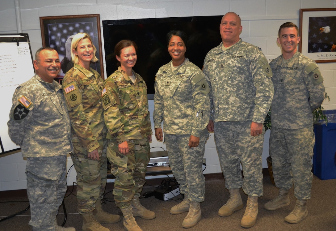 After a mission briefing, 1st Sgt. Robert Balcazar, 227th Inland Cargo Transfer Company first sergeant, Capt. Christen Brown, 227th ICTC company commander, Lt. Col. (P) Chandra Roberts, 469th Combat Sustainment Support Battalion commander, Col. Toni Glover, 650th Regional Support Group commanding officer, Command Sgt. Maj. Mario Canizales, 650th RSG command sergeant major, and 1st Lt. Kyle Reilly, 924th Transportation Company commander, pose for a picture at the Sierra Army Depot June 10, during an annual training event June 10.