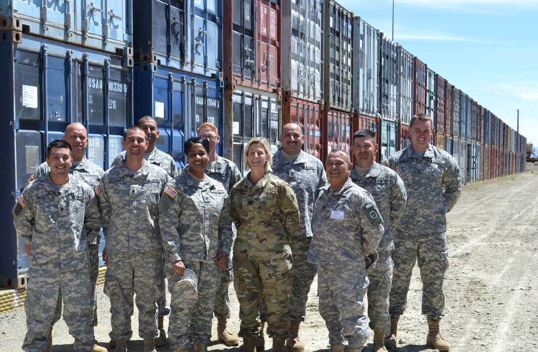 Col. Toni Glover, 650th Regional Support Group commanding officer, Capt. Christen Brown, 227th Inland Cargo Transfer Company company commander, and Command Sgt. Maj. Mario Canizales, 650th RSG command sergeant major, pose with Soldiers from the 227th ICTC at the container yard at the Sierra Army Depot June 10, during an annual training event. The Sierra Army Depot is an ammunition and surplus storage terminal, located near the unincorporated community of Herlong, California.
