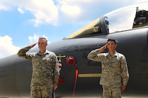 Staff Sgt. Adam Kipper (left) and Senior Airman Nicholas Landi (right), 4th Aircraft Maintenance Squadron dedicated crew chiefs, render salutes to Col. Christopher Sage, 4th Fighter Wing commander, after unveiling Sage’s name on the flagship F-15E Strike Eagle aircraft, June 30, 2016, at Seymour Johnson Air Force Base, North Carolina. Sage has supported operations NORTHERN WATCH, DELIBERATE FORGE, ALLIED FORCE, ENDURING FREEDOM and IRAQI FREEDOM and has logged more than 4,100 flight hours during his 22-year career. (U.S. Air Force photo/Airman 1st Class Ashley Williamson)