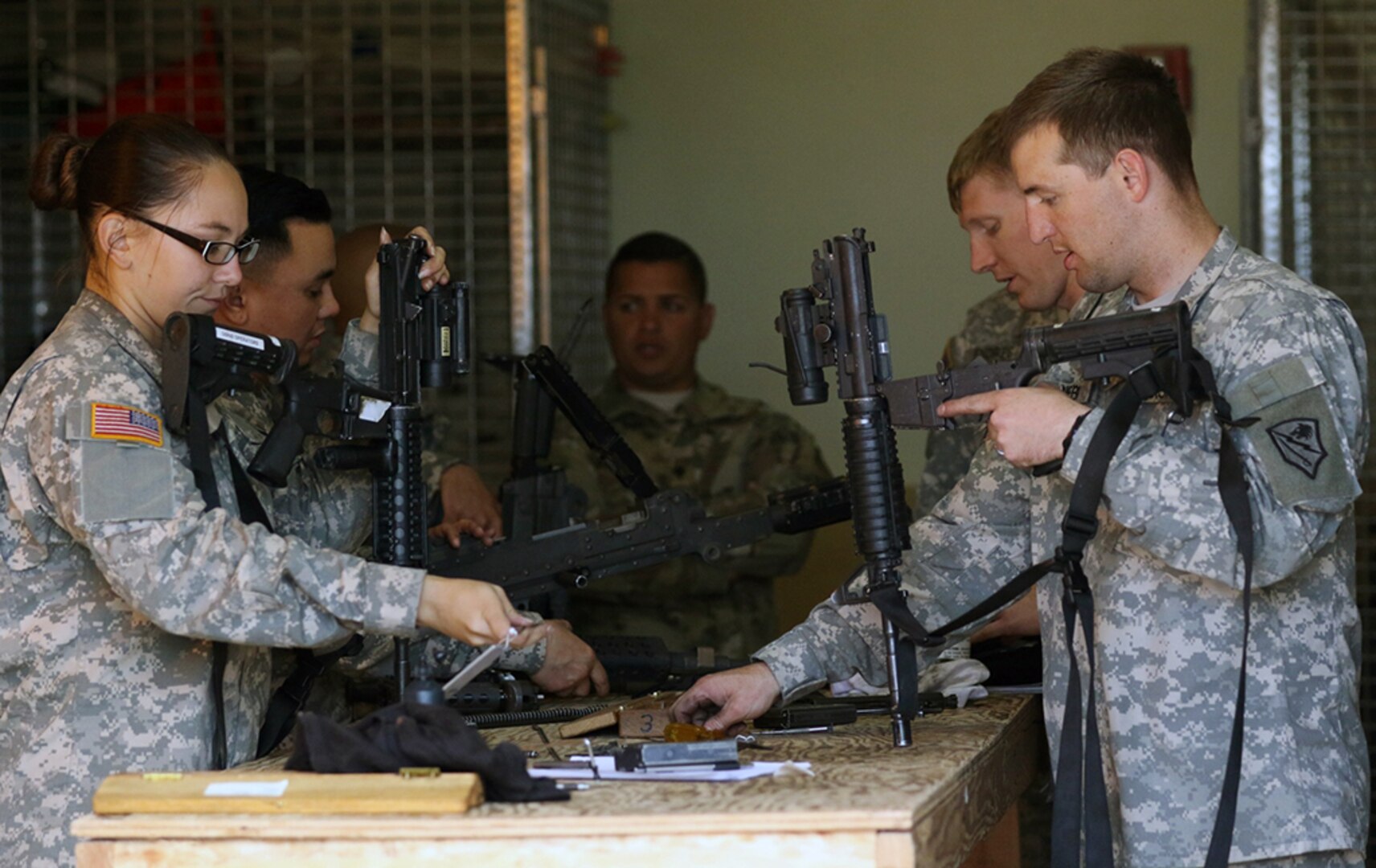 In this photo, small-arms repairers from the Alaska and Arizona Army National Guards inspect M4 carbines and M240 machine guns at Fort Greely.  The Arizona Guard was invited to Alaska to assist in weapons and night vision optics inspections for the Alaska National Guard's 49th Missile Defense Battalion.