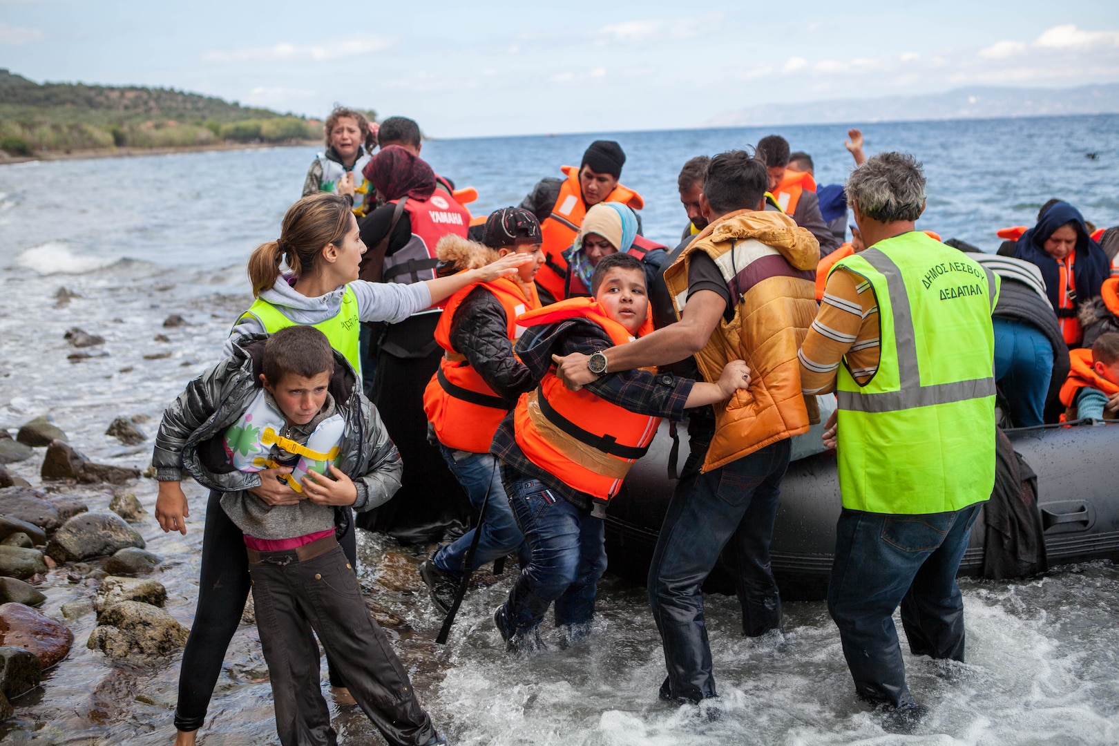 Syrian and Iraqi immigrants getting off a boat from Turkey on the Greek island of Lesbos.