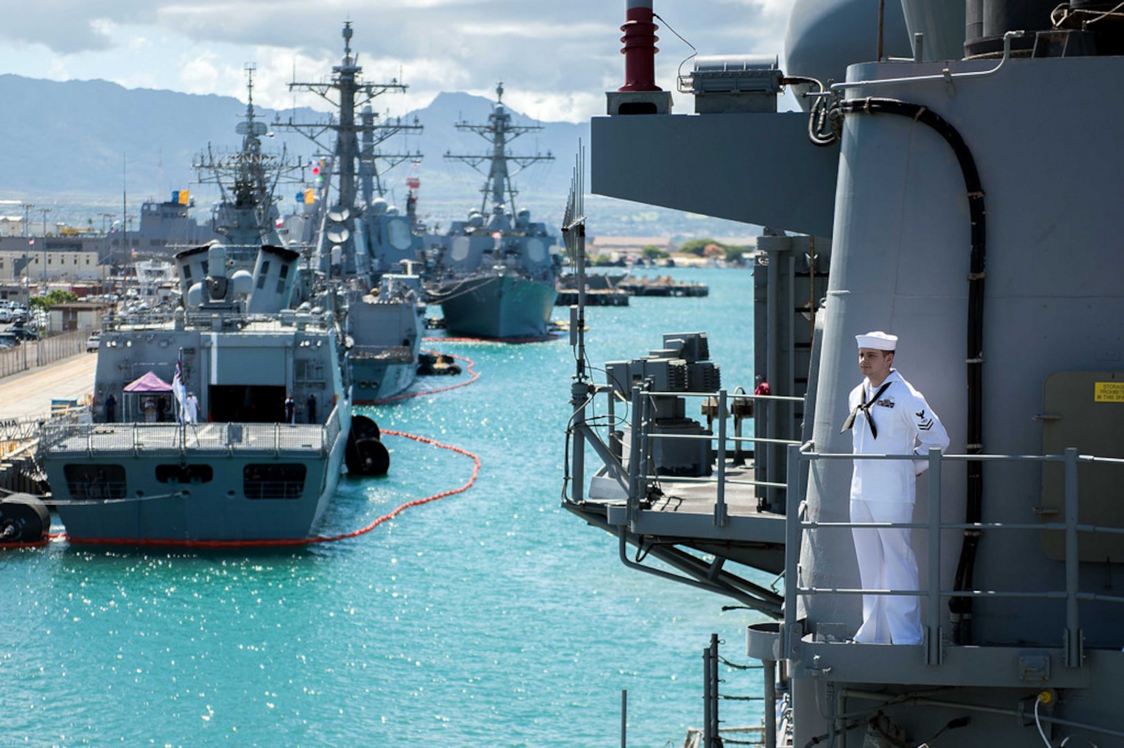PEARL HARBOR, Hawaii  (June 28, 2016) - Fire Controlman 2nd Class Michael Klimek mans the rails aboard the guided-missile cruiser USS Mobile Bay (CG 53) as the ship prepares to moor at Joint Joint Base Pearl Harbor-Hickam to participate in exercise Rim of the Pacific 2016. Twenty-six nations, more than 40 ships and submarines, more than 200 aircraft and 25,000 personnel are participating in RIMPAC from June 30 to Aug. 4, in and around the Hawaiian Islands and Southern California. The world's largest international maritime exercise, RIMPAC provides a unique training opportunity that helps participants foster and sustain the cooperative relationships that are critical to ensuring the safety of sea lanes and security on the world's oceans. RIMPAC 2016 is the 25th exercise in the series that began in 1971. 