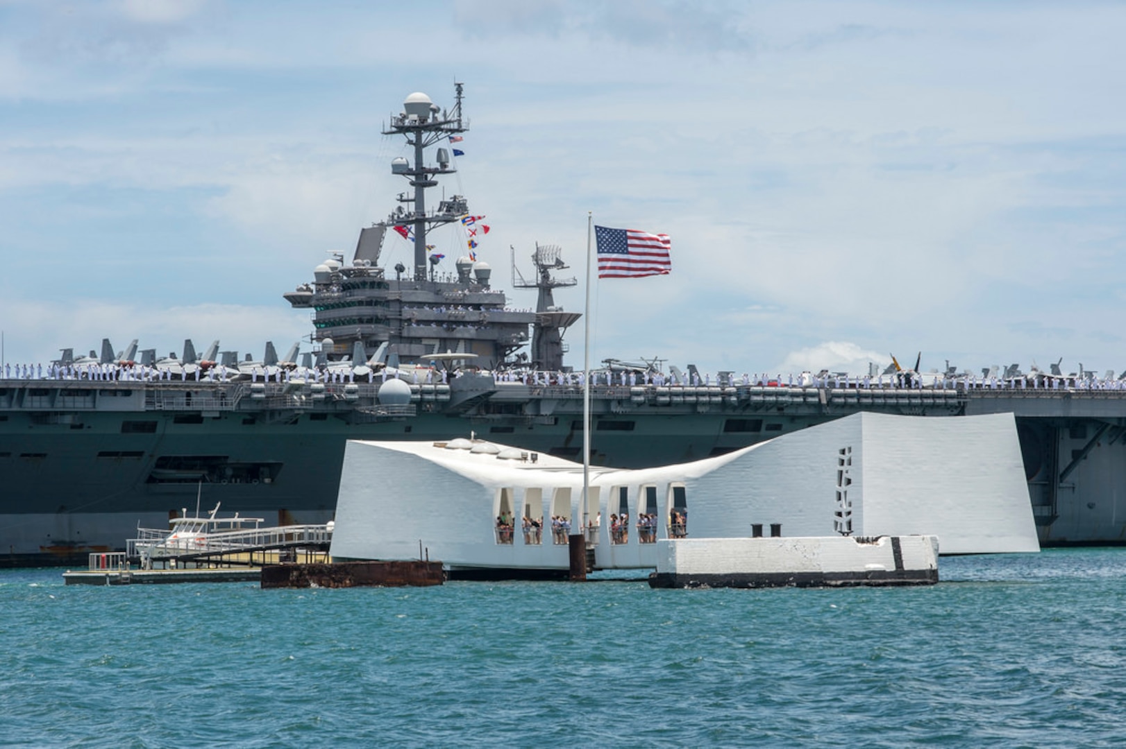 PEARL HARBOR, Hawaii - USS John C. Stennis (CVN 74) passes the USS Arizona Memorial as the Nimitz class aircraft carrier arrives at Joint Base Pearl Harbor-Hickam for Rim of the Pacific 2016. Twenty-six nations, more than 40 ships and submarines, more than 200 aircraft and 25,000 personnel are participating in RIMPAC from June 30 to Aug. 4, in and around the Hawaiian Islands and Southern California. The world's largest international maritime exercise, RIMPAC provides a unique training opportunity that helps participants foster and sustain the cooperative relationship that are critical to ensuring the safety of sea lanes and security on the world's oceans. RIMPAC 2016 is the 25th exercise in the series that began in 1971. 