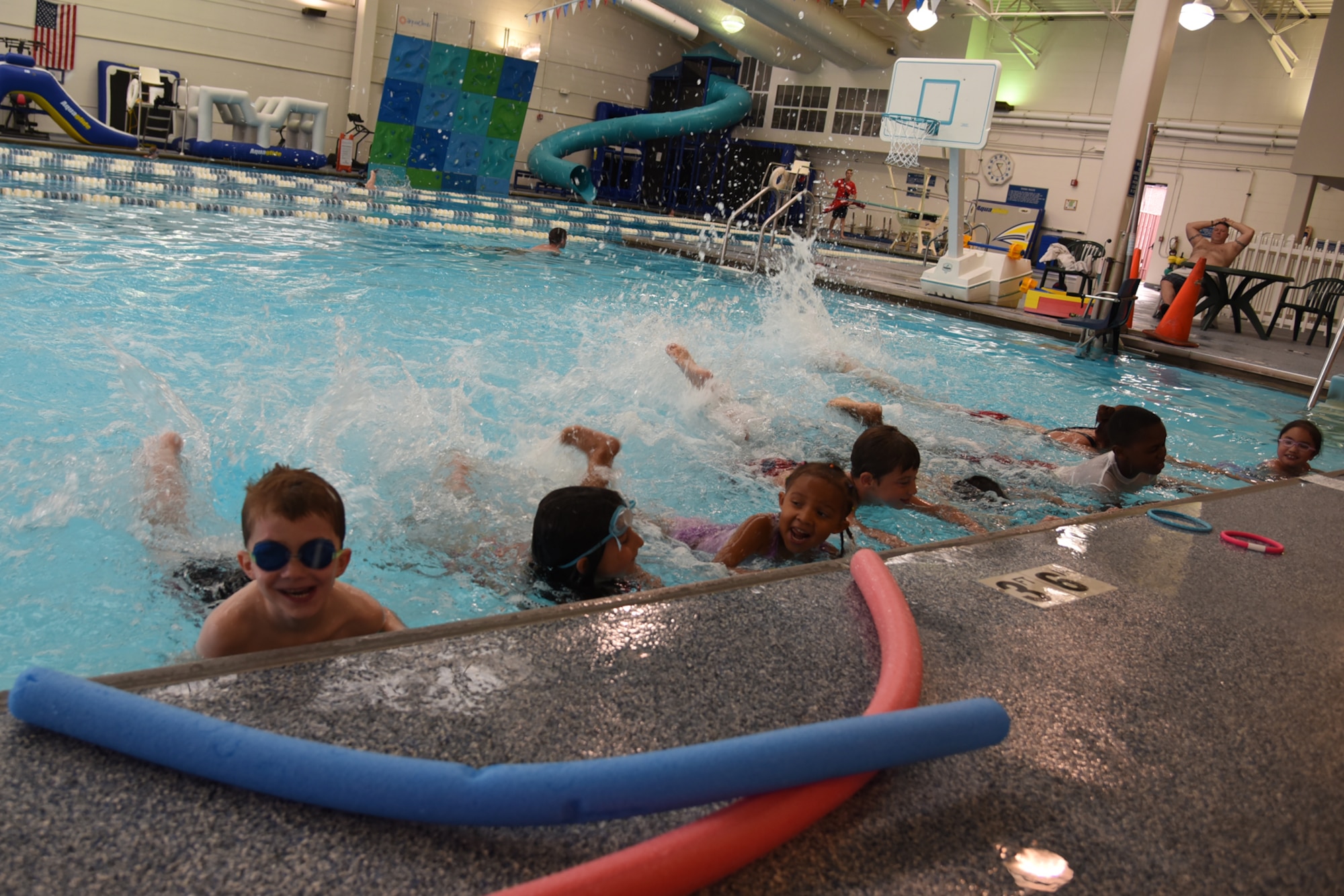 PETERSON AIR FORCE BASE, Colo. – Jaimie Dietle, Peterson Aquatics Center lead lifeguard, teaches swimmers how to properly kick while swimming during the World’s Largest Swimming Lesson at the Peterson Aquatics Center on Peterson Air Force Base, Colo., June 24, 2016. Teaching children to swim is a vital skill for drowning prevention along with other key water safety measures that everyone can take to stay safe in and around the water. (U.S. Air Force photo by Airman 1st Class Dennis Hoffman)
