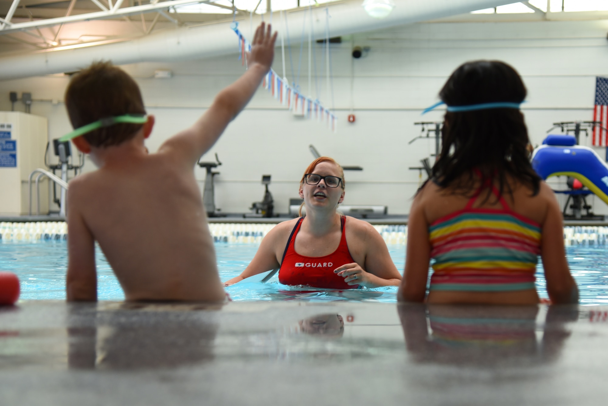 PETERSON AIR FORCE BASE, Colo. – Jaimie Dietle, Peterson Aquatics Center lead lifeguard, answers swimming questions before the World’s Largest Swimming Lesson at the Peterson Aquatics Center on Peterson Air Force Base, Colo., June 24, 2016. The World’s Largest Swimming Lesson builds awareness about the vital importance of teaching children to swim to help prevent drowning. (U.S. Air Force photo by Airman 1st Class Dennis Hoffman)