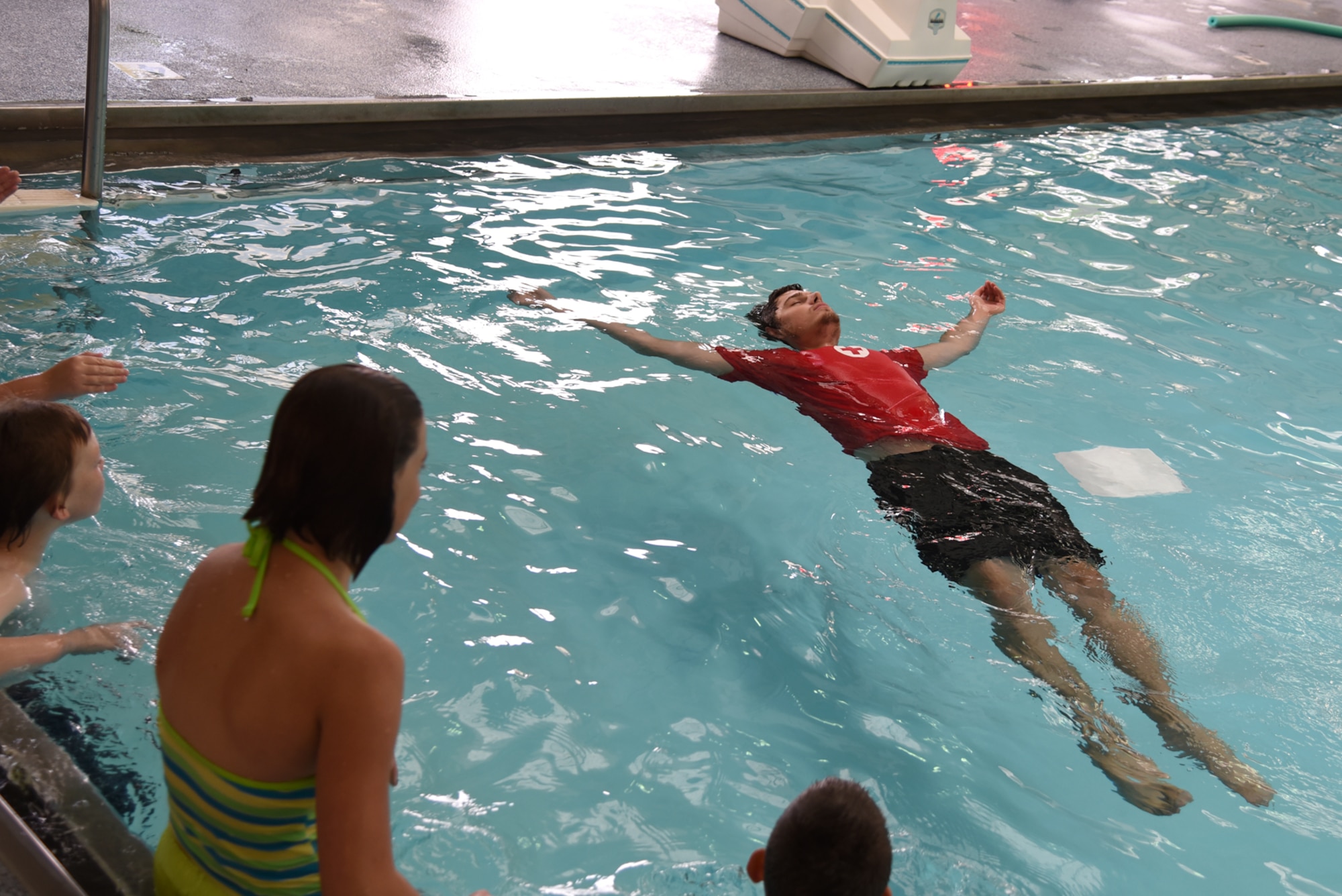 PETERSON AIR FORCE BASE, Colo. – Jacob Goulette, Peterson Aquatics Center lead lifeguard, displays the proper way to float on your back during the World’s Largest Swimming Lesson at the Peterson Aquatics Center on Peterson Air Force Base, Colo., June 24, 2016. Swimming is a life-saving skill for children and a vital tool to prevent drowning, the second leading cause of unintended, injury-related death for children ages one to 14. (U.S. Air Force photo by Airman 1st Class Dennis Hoffman)