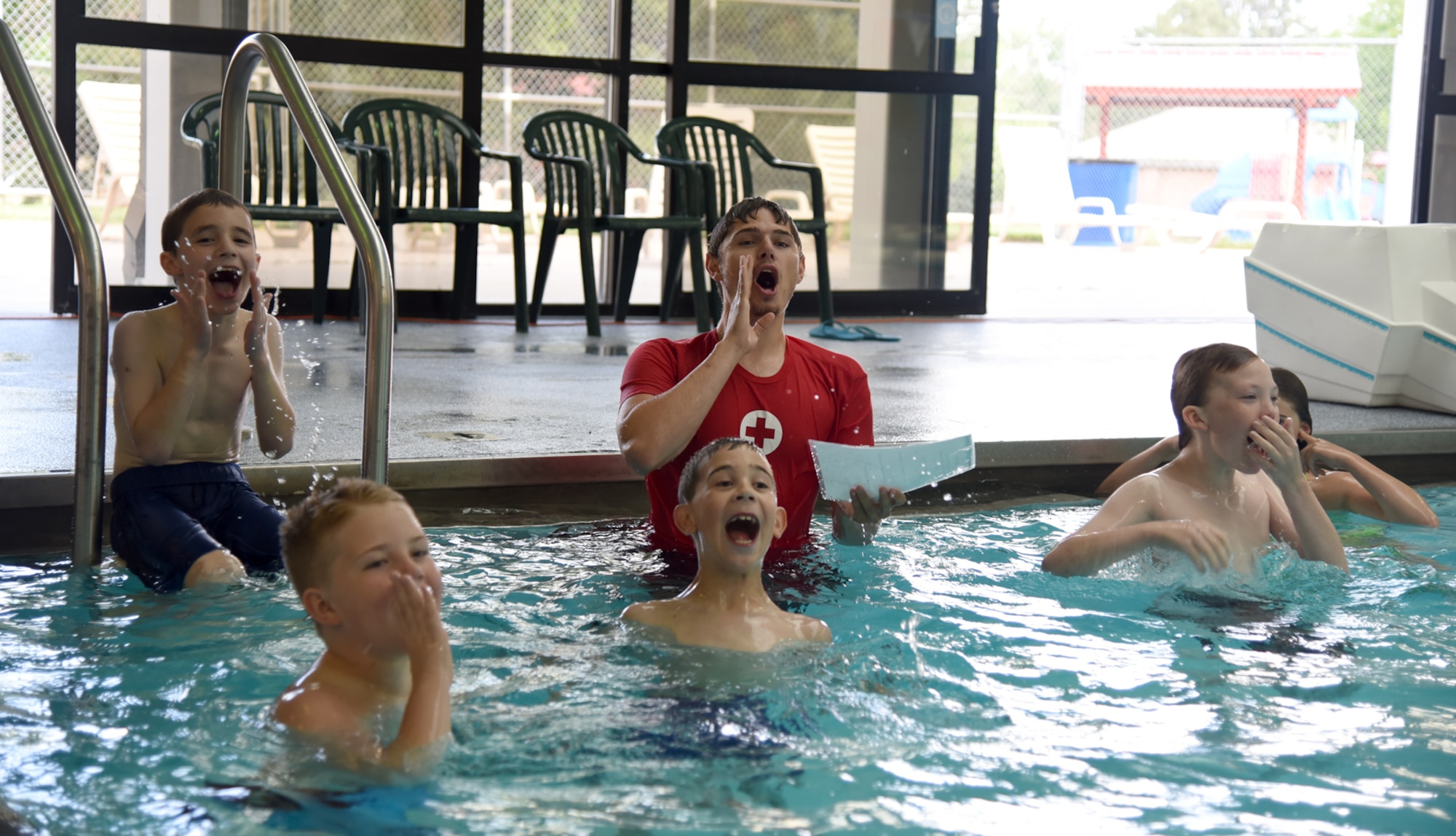 PETERSON AIR FORCE BASE, Colo. – Jacob Goulette, Peterson Aquatics Center lead lifeguard, teaches swimmers how to effectively rgab the attention of other lifeguards if anyone should need their help during the World’s Largest Swimming Lesson at the Peterson Aquatics Center on Peterson Air Force Base, Colo., June 24, 2016. The World’s Largest Swimming Lesson builds awareness about the vital importance of teaching children to swim to help prevent drowning. (U.S. Air Force photo by Airman 1st Class Dennis Hoffman)