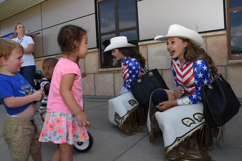 Allison Mitchell Girl of the West and Jamie Tyler Aide to Girl of the West talk to Child Development Center children at Schriever Air Force Base, Colorado, Friday, June 24, 2016. Allison and Jaime are honored to represent the Pikes Peak or Bust Rodeo, along with raising awareness and support for our local military and their families. (U.S. Air Force Photo/Staff Sgt. Matthew Coleman-Foster)
