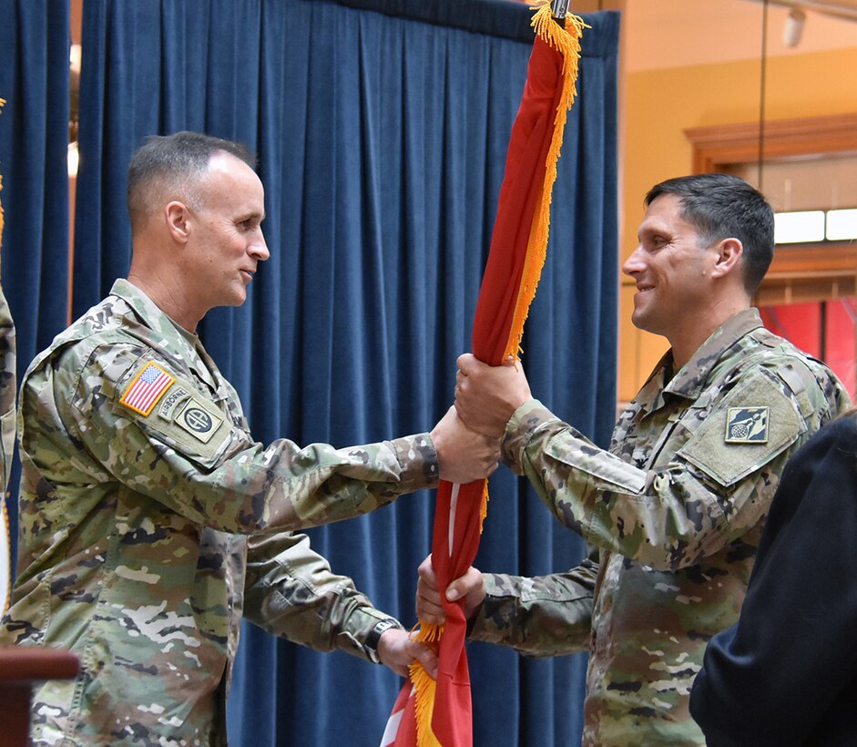 Col. Sam Calkins, St. Paul District commander, receives the unit colors from Major Gen. Michael Wehr, Mississippi Valley Division commander, during a change of command ceremony at the Landmark Center in St. Paul, Minnesota, June 30. Wehr officiated the ceremony and welcomed Calkins as the incoming commander He also bid farewell to the outgoing commander, Col. Dan Koprowski.