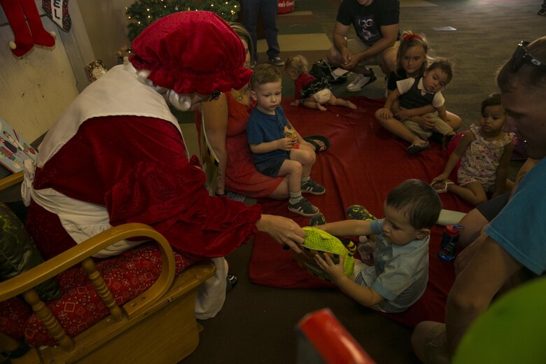 Mrs. Claus reads a book to children at the Armed Services YMCA’s first Christmas You Missed event held at building 1707 aboard the Marine Corps Air Ground Combat Center Twentynine Palms, Calif., June 25, 2016. (Official Marine Corps photo by Lance Cpl. Dave Flores/Released)