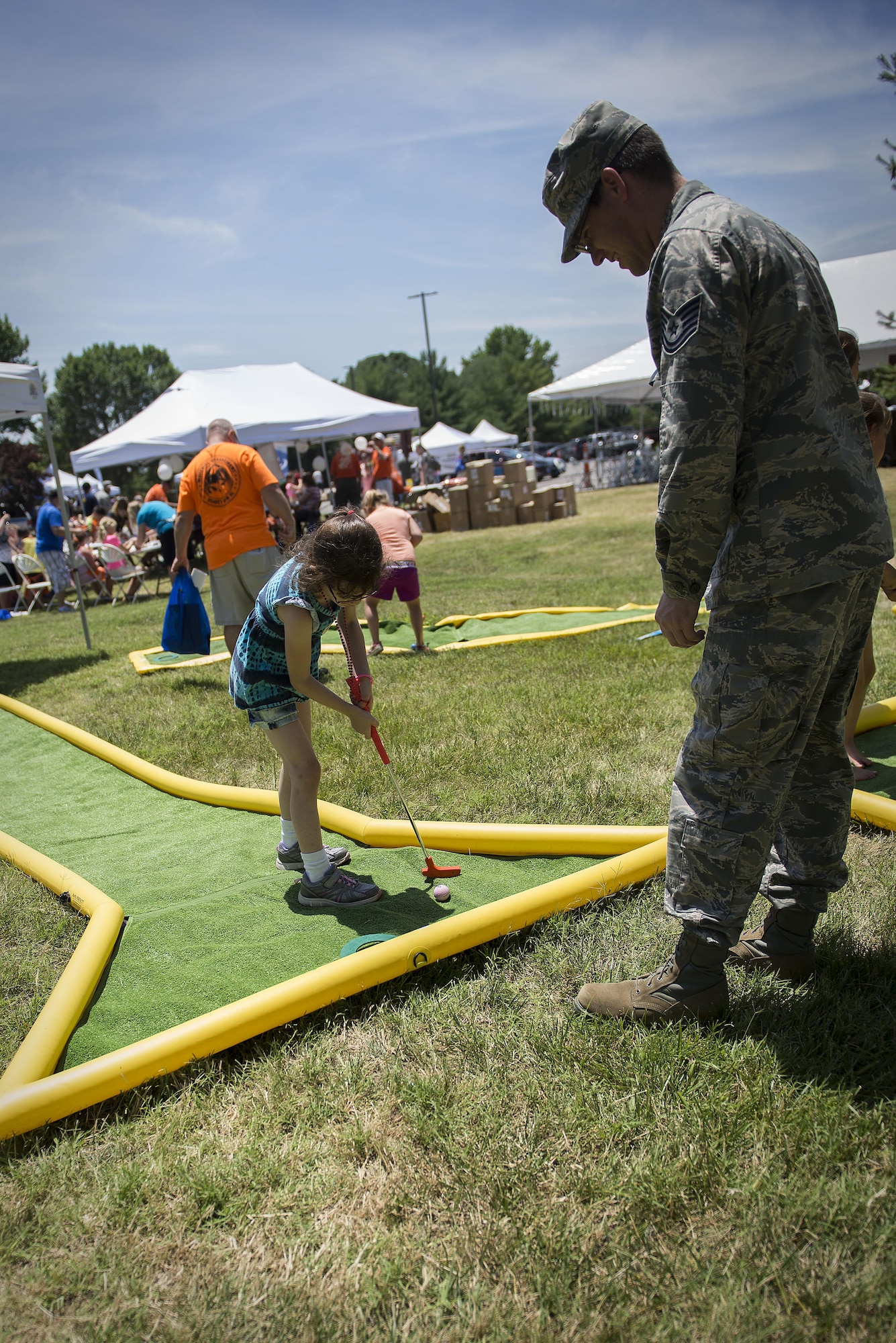 Team Scott members play golf at an activity booth at the Scott Air Force Base Annual Base Picnic June 24, 2016. The base picnic was created to celebrate the base's and Air Force's diversity. (U.S. Air Force photo/Senior Airman Jake Eckhardt)