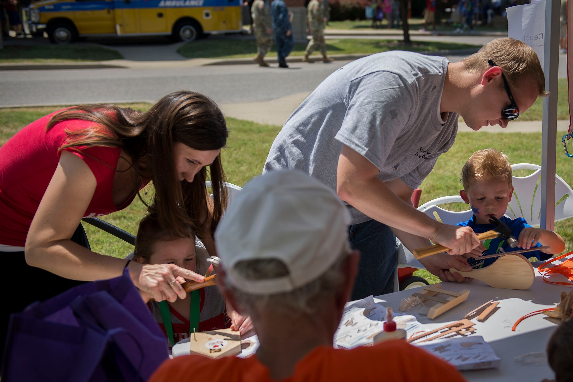 Team Scott members build small wooden aircraft and houses at an activity booth at the Scott Air Force Base Annual Base Picnic June 24, 2016. The base picnic was created to celebrate the base's and Air Force's diversity. (U.S. Air Force photo/Senior Airman Jake Eckhardt)