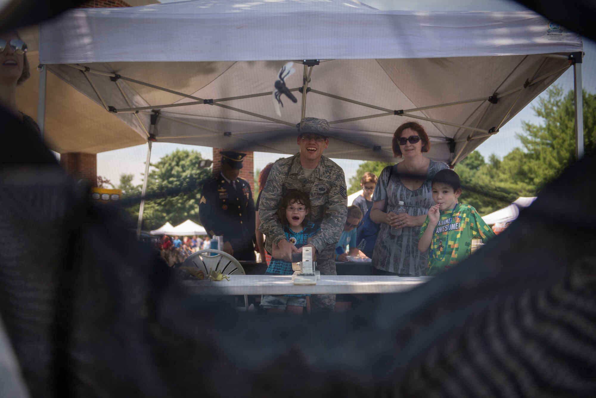 Team Scott members attempt to bounce a "bug" into a net at an activity booth at the Scott Air Force Base Annual Base Picnic June 24, 2016. The base picnic was created to celebrate the base's and Air Force's diversity. (U.S. Air Force photo/Senior Airman Jake Eckhardt)