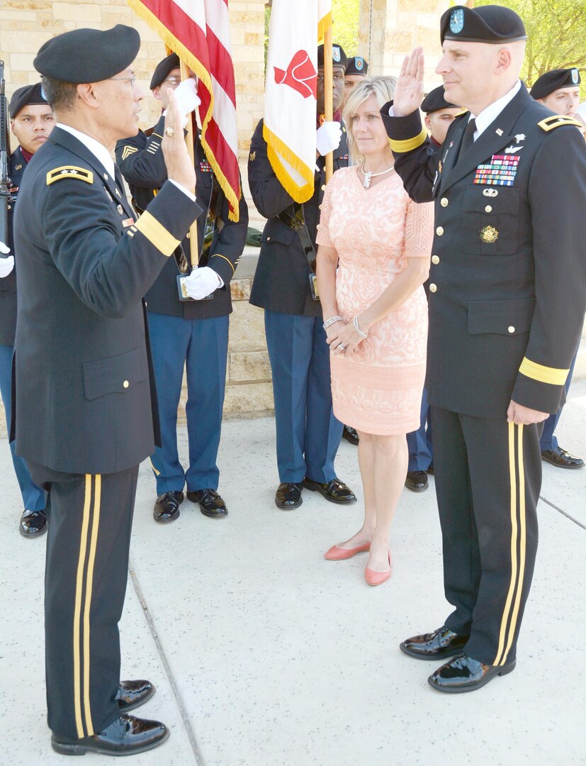 Maj. Gen. Joseph Caravalho Jr. administers the oath of office to Brig. Gen.Jeffrey Johnson during a promotion ceremony June 21 at the Warrior and Family Support Center Amphitheater at Fort Sam Houston. Caravalho is the Joint Staff Surgeon at the Pentagon and former BAMC commander.