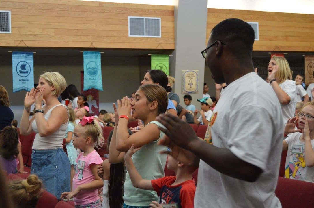 Combat Center families and Vacation Bible School volunteers sing during the Vacation Bible School at the Protestant Chapel aboard the Marine Corps Air Ground Combat Center, Twentynine Palms, Calif. The Vacation Bible School is a weeklong event used to strengthen children’s faith.