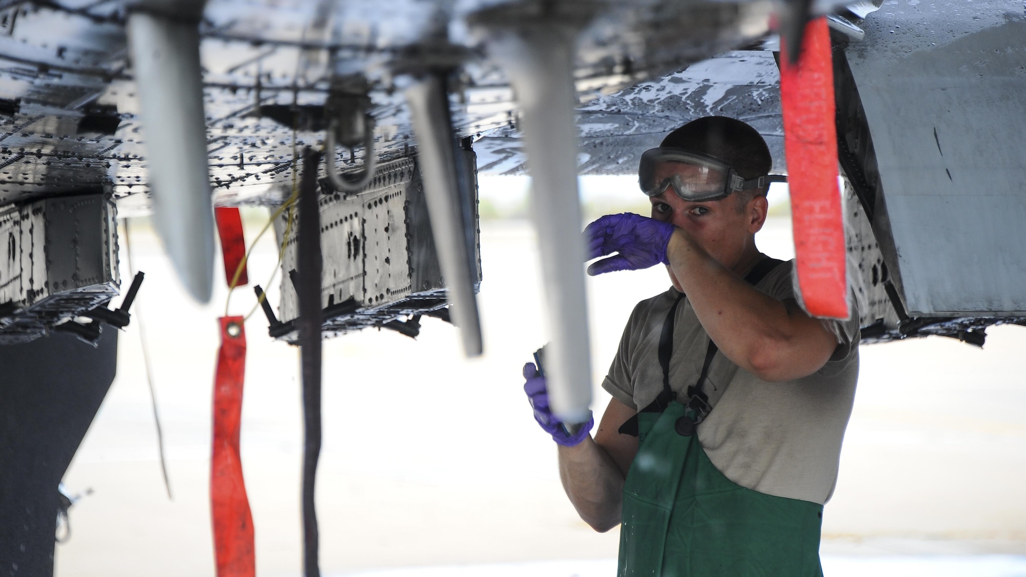 U.S. Air Force Airman 1st Class Ryan Meilleur, 354th Aircraft Maintenance Unit crew chief, wipes his face while cleaning an A-10C Thunderbolt II on the flightline of Davis-Monthan Air Force Base, Ariz., June 29, 2016. The 354th AMU’s parent unit, 355th Aircraft Maintenance Squadron, generates all combat and training sorties in the 355th Fighter Wing and manages the efforts of 571 personnel in 13 different specialties of maintaining A-10 attack aircraft. (U.S. Air Force photo by Airman 1st Class Mya M. Crosby/Released)