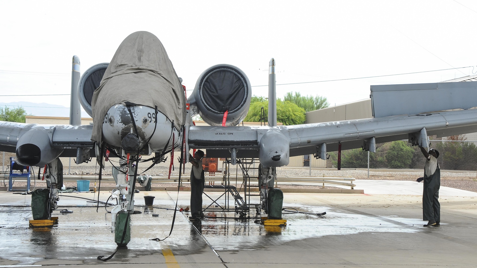 U.S. Airmen assigned to the 354th Aircraft Maintenance Unit wash an A-10C Thunderbolt II on the flightline of Davis-Monthan Air Force Base, Ariz., June 29, 2016. The 354th AMU’s parent unit, 355th Aircraft Maintenance Squadron, generates all combat and training sorties in the 355th Fighter Wing and manages the efforts of 571 personnel in 13 different specialties of maintaining A-10 attack aircraft. (U.S. Air Force photo by Airman 1st Class Mya M. Crosby/Released)