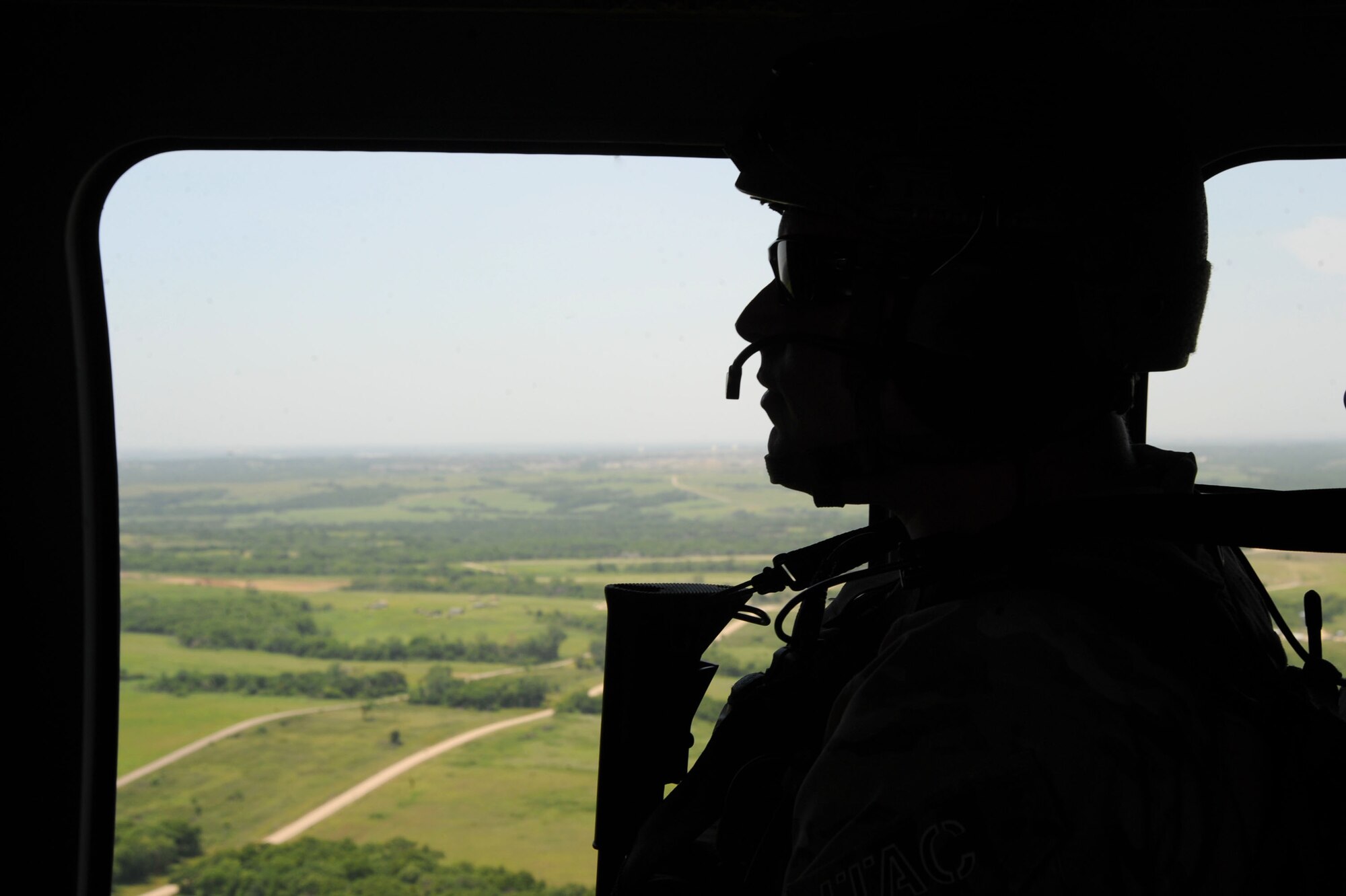 A 10th Air Support Operations Squadron joint terminal attack control Airman rides in a UH-60 Blackhawk during a joint operations aircrew recovery exercise, June 22, 2016, at Fort Riley, Kan. JTAC Airmen train regularly for their responsibilities of calling in close air support to maintain mission readiness. (U.S. Air Force photo/Airman 1st Class Jenna K. Caldwell)